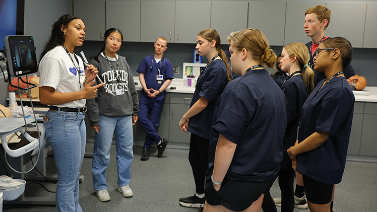 Medical students Desiree Schafer and Laney Hoyt explain how to intubate a patient to students attending the College of Medicine and Life Sciences’ Future Doctors Camp.