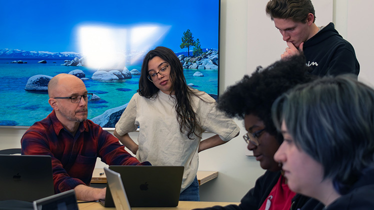 Barry Whittaker, left, professor of graphic and interactive design, works with UToledo students on the “Birds in Art: Devotion and Decadence” online exhibit. 