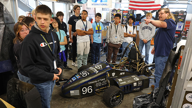Seth Sorensen, program manager of Academic College Enrollment in the College of Engineering, talks to high school students about the college's Formula SAE race car at UToledo's Engineering Summer Camp, which wraps up Friday.