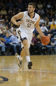 Nathan Boothe dribbles basketball during a game.