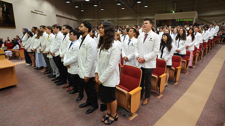 Incoming medical students recite their oath during the white coat ceremony