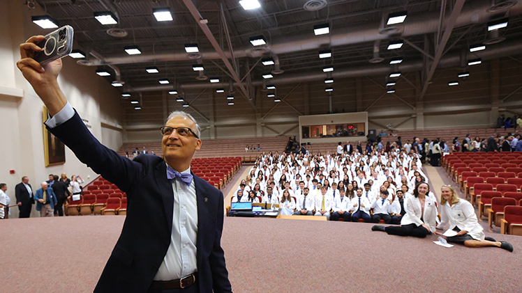 Dr. Imran Ali, dean of the UToledo College of Medicine and Life Sciences, takes a selfie with the M.D. Class of 2030 on Friday during the college's annual White Coat Ceremony.