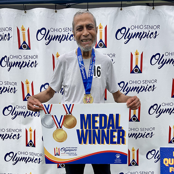 Ab Khan celebrates his gold medal in power walking at the Ohio Senior Olympics