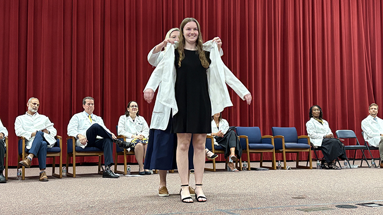 Incoming Pharm D student Katherine Eaton receives her white coat on Thursday as the UToledo College of Pharmacy and Pharmaceutical Sciences held its annual White Coat Ceremony.