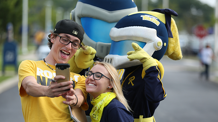 Students take a selfie with Mascots Rocky and Rocksy at the President's Tailgate.