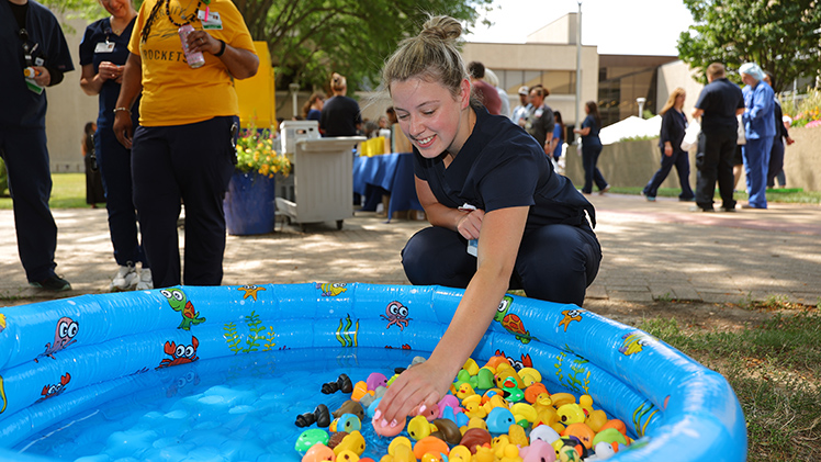 Autum Wessling, a pharmacy technician, picks a rubber duck for a prize during Thursday’s annual Employee Appreciation Summerfest 2026 on Health Science Campus.