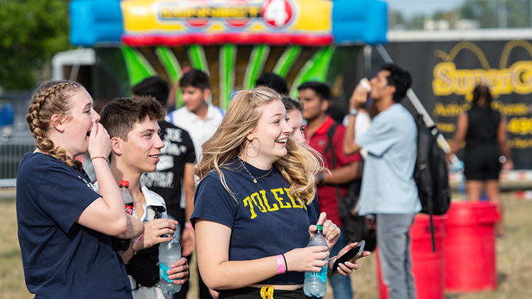 Photo of UToledo students smiling at the CAP Carnival event. 