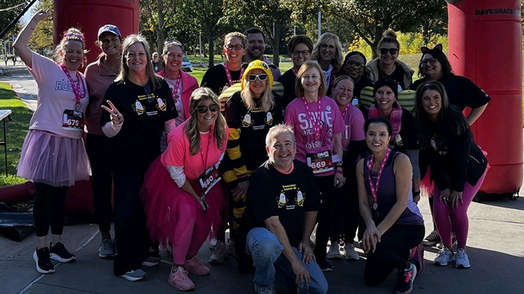 A group of staff from the Eleanor N. Dana Cancer Center celebrate during the inaugural Breast Cancer Awareness 5K in 2025.