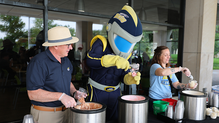 President Holloway watches as Rocky makes his own sundae treat.