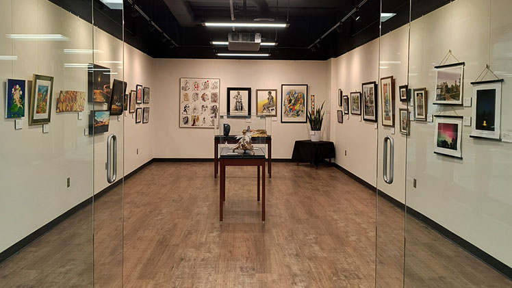 Photo of a University Libraries gallery with artwork hanging on the walls.