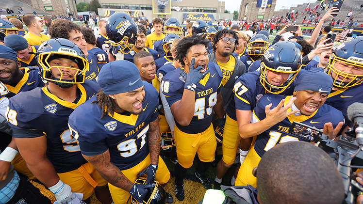 The Toledo football team celebrates on the field after pulling off one of the most unlikely comebacks in program history, rallying to stun Temple, 49-48, in an overtime thriller at Glass Bowl Stadium on Saturday.