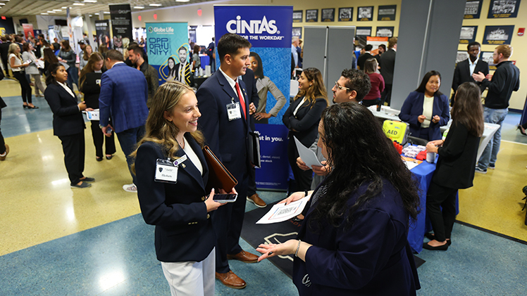 A student networks with a company representative at the Fall Job Fair in 2025. The Neff College of Business hosts semiannual job fairs to support students seeking internships and post-graduation employment.