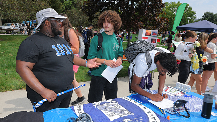 From left, Donavan Chislom, a senior in political science, speaks to Draeden Ellis and Roy Williams, both freshmen in the College of Engineering, about Phi Beta Sigma Fraternity Inc. at Wednesday’s Campus Involvement Fair.