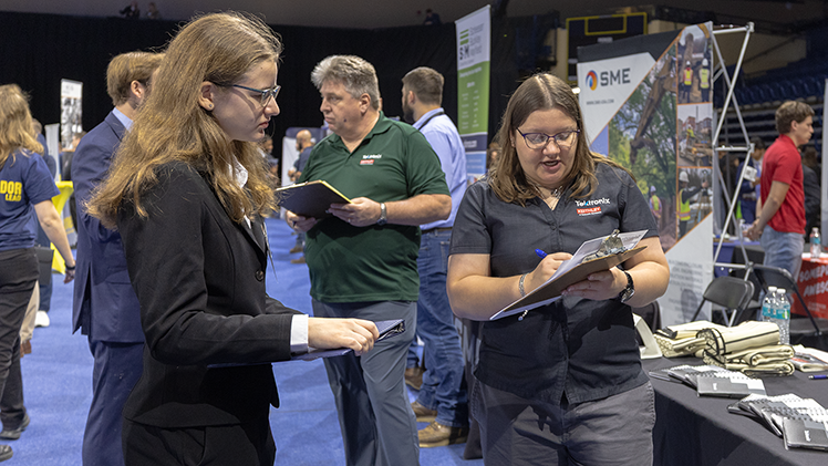 Katie Benson, left, a sophomore in computer science and engineering, meets with Tektronix company representative Elizabeth Makley.