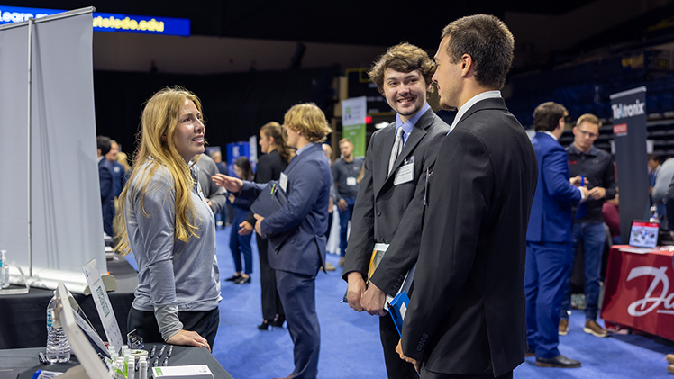 Ryan Scarborough, right, a sophomore in civil engineering, and Schuyler Alexander, center, a senior in computer science and engineering, talk with Hanna Myers, a representative from The Gerken Companies.
