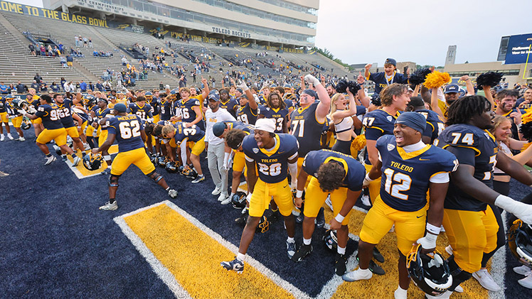 The Toledo football team celebrates on the field after pulling off one of the most unlikely comebacks in program history, rallying to stun Temple, 49-48, in an overtime thriller at Glass Bowl Stadium on Saturday.