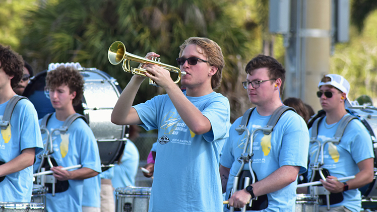 Photo of Luke Boyd, a sophomore Pharm.D. major and member of the Rocket Marching Band, playing trumpet during a band practice.