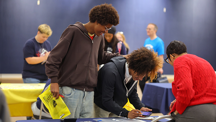 Nate Crain, a sophomore at Northwest Ohio Classical Academy, consoles his friend Ketha Jerome Harrison, a sophomore at Northwest Ohio Classical Academy, as he calculates his household budget.