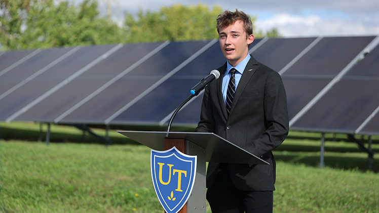Jaden Bollinger, student government president, speaks at a ribbon-cutting ceremony for a solar array expansion.
