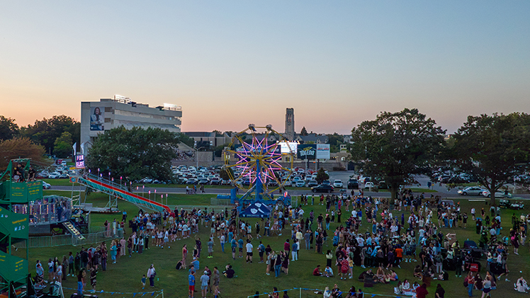 Drone photo of UToledo's CAP Carnival with a ferris wheel and other rides.