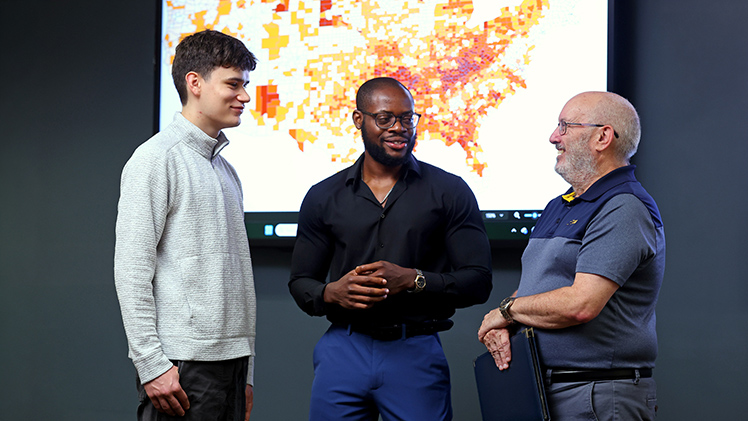 From right, Dr. Patrick Lawrence, a professor and chair of the Judith Herb College of Arts, Social Sciences and Education’s Department of Geography and Planning, speaks with Ph.D. candidate Oluwaseun Ibukun and undergraduate Jack Cowell.