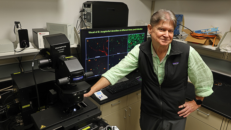 Portrait of Dr. Mark Wooten, a professor in the Department of Medical Microbiology and Immunology, in his lab.